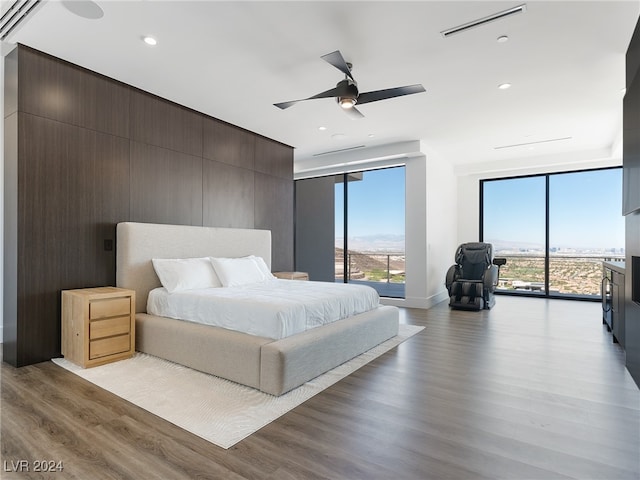 bedroom featuring ceiling fan, light hardwood / wood-style flooring, and access to exterior