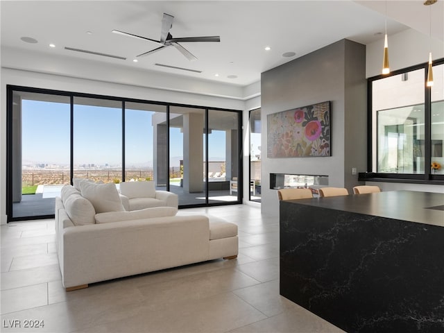 tiled living room with ceiling fan