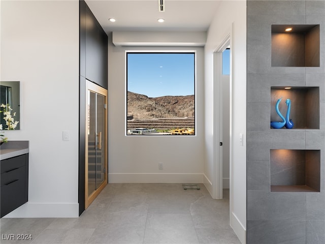 bathroom featuring tile patterned flooring, a healthy amount of sunlight, and vanity