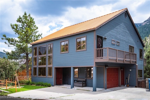 view of front of house with a garage and a balcony