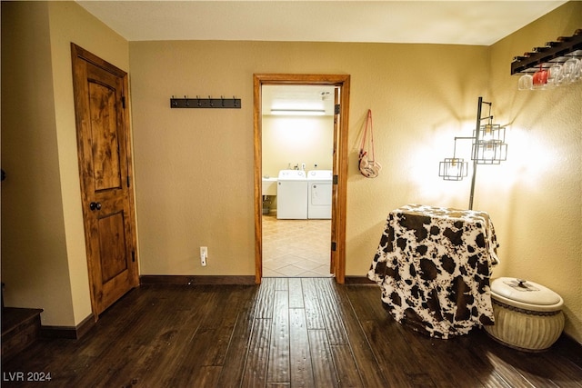 interior space with connected bathroom, washing machine and clothes dryer, and wood-type flooring