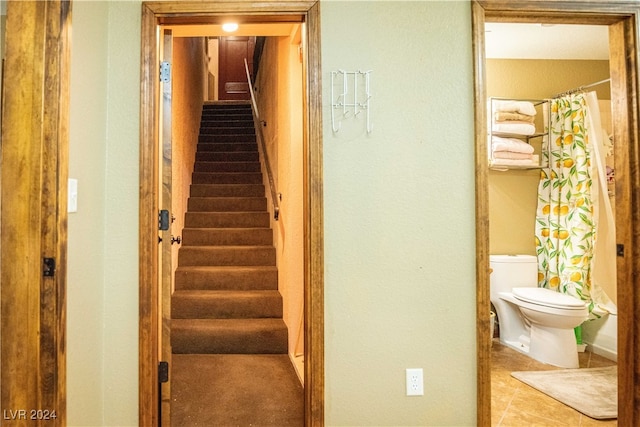 staircase featuring tile patterned flooring