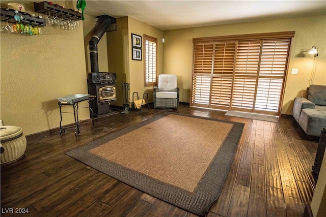 living room featuring dark hardwood / wood-style flooring and a wood stove