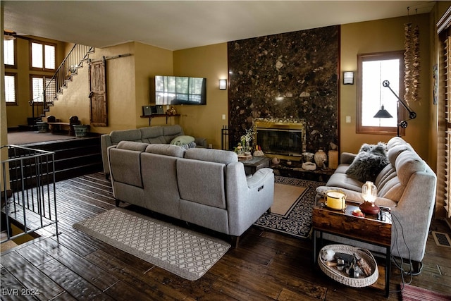 living room featuring dark hardwood / wood-style flooring and a fireplace