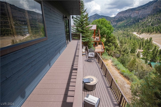 wooden terrace featuring cooling unit and a mountain view