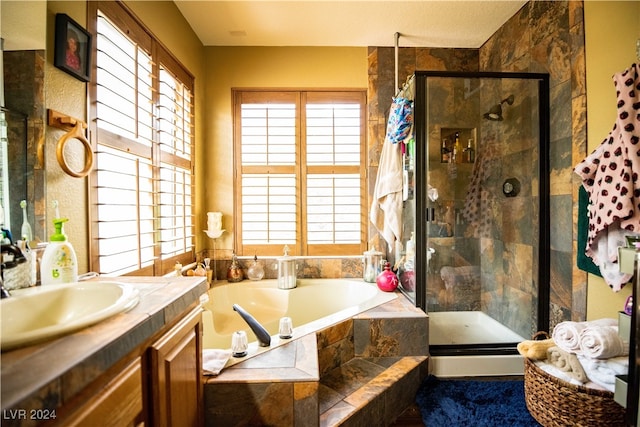 bathroom featuring vanity and shower with separate bathtub