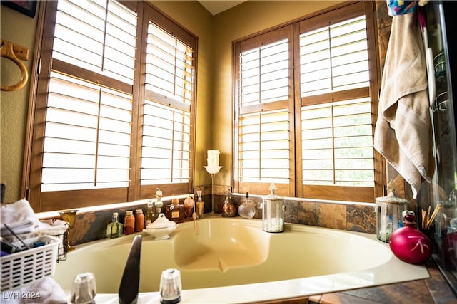 bathroom featuring a relaxing tiled tub