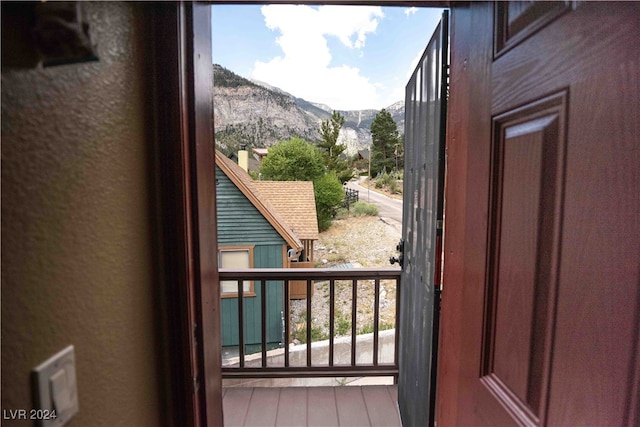 doorway with a mountain view and hardwood / wood-style flooring