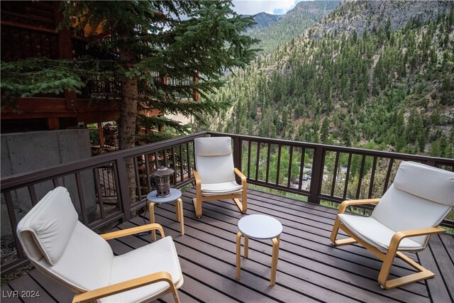 wooden deck with a mountain view