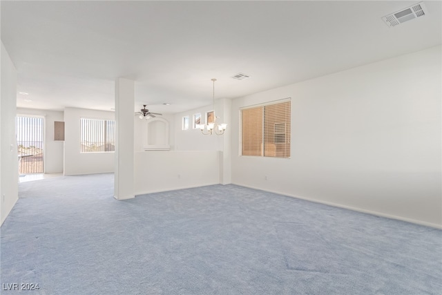 interior space featuring ceiling fan with notable chandelier and light colored carpet