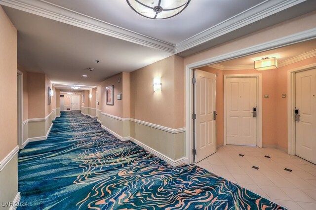 corridor with crown molding and tile patterned flooring