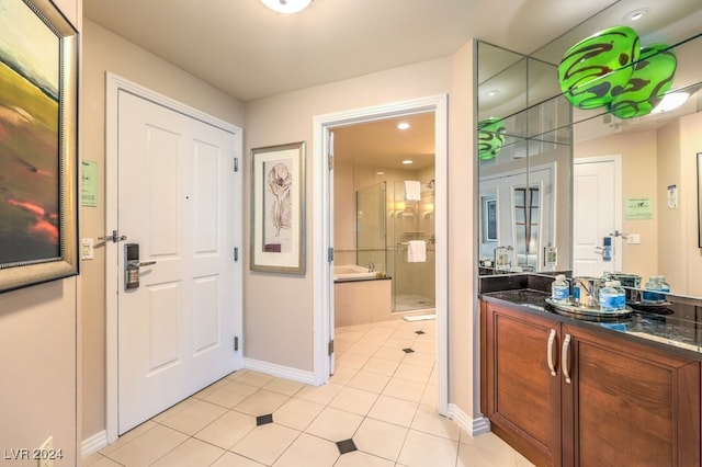 foyer entrance featuring baseboards and light tile patterned flooring