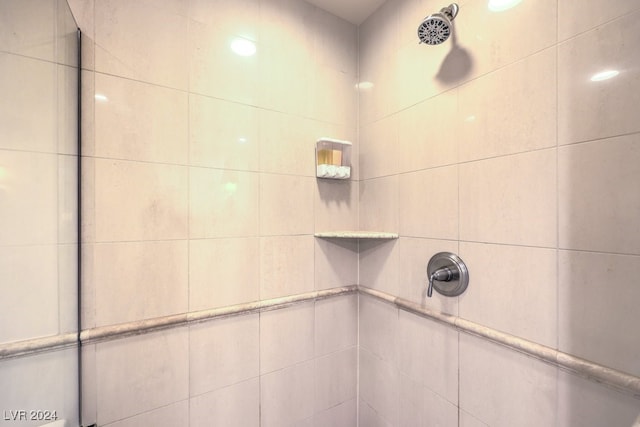 bathroom with a tile shower