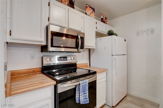 kitchen featuring white cabinetry, stainless steel appliances, and light hardwood / wood-style flooring