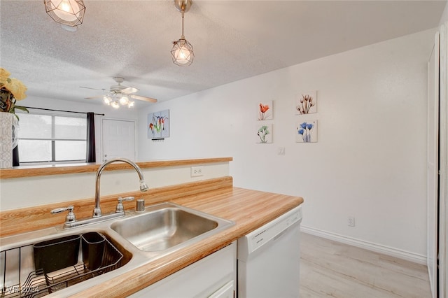 kitchen with sink, decorative light fixtures, white dishwasher, a textured ceiling, and ceiling fan