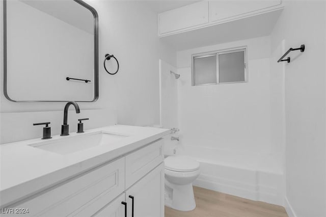 full bathroom with shower / tub combination, vanity, toilet, and hardwood / wood-style floors