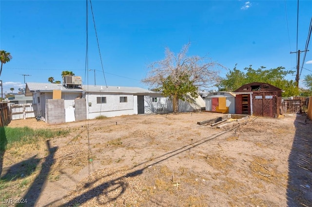 back of property featuring an outdoor structure and central air condition unit