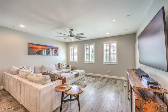 living room featuring light hardwood / wood-style floors and ceiling fan