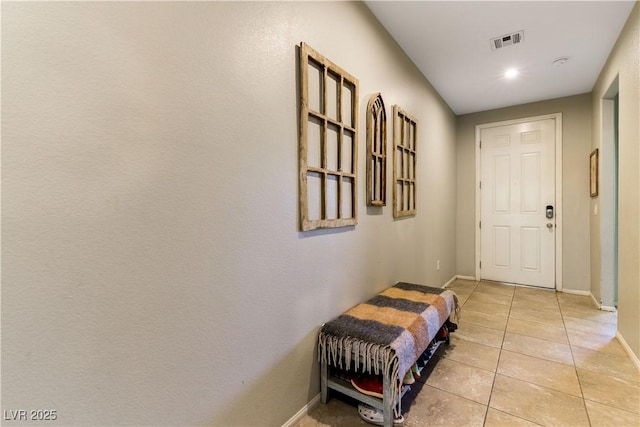 doorway with light tile patterned floors