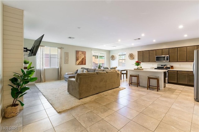 living room with light tile patterned floors and a healthy amount of sunlight