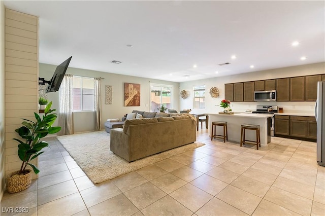 living room with light tile patterned floors and a wealth of natural light