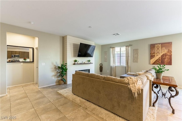 tiled living room featuring a fireplace