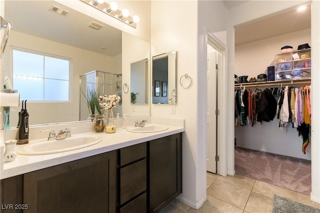 bathroom featuring vanity, an enclosed shower, and tile patterned flooring