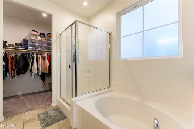 bathroom featuring plus walk in shower and tile patterned floors