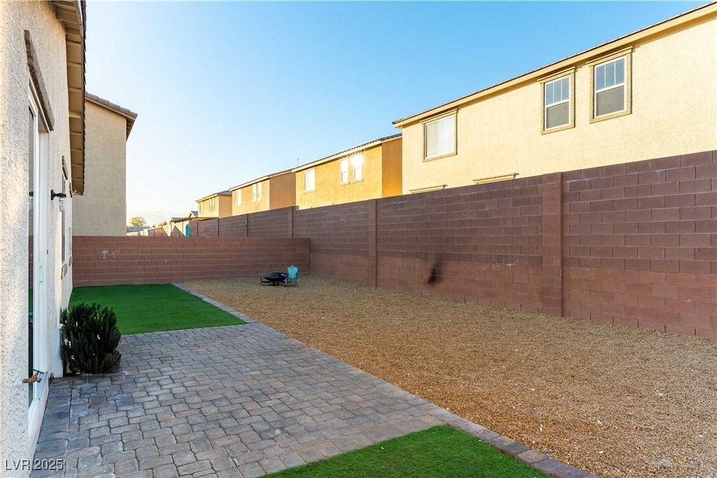 view of yard with a fenced backyard and a patio