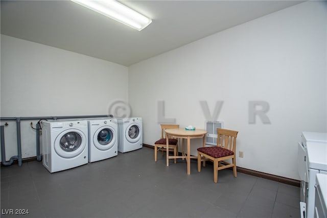 laundry room with washing machine and clothes dryer and tile patterned floors