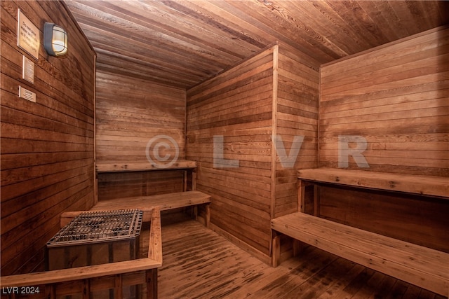 view of sauna featuring wooden ceiling, wood-type flooring, and wooden walls