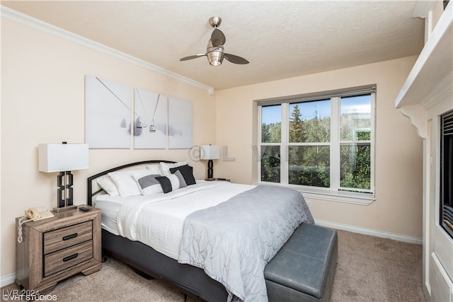 bedroom with ceiling fan, light colored carpet, and a textured ceiling