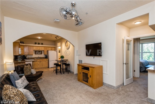 carpeted living room featuring a textured ceiling