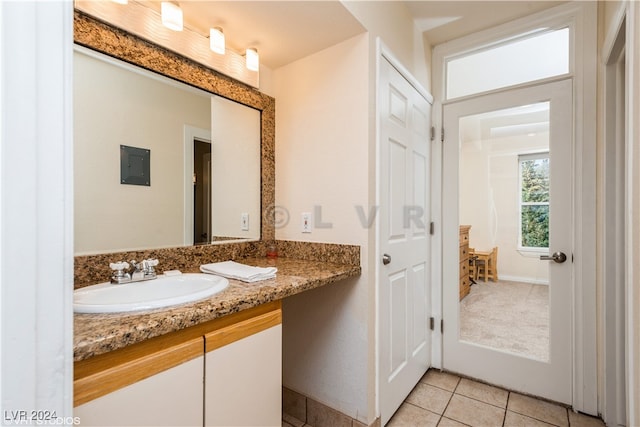 bathroom with tile patterned flooring, vanity, and electric panel