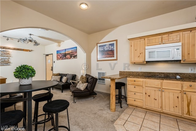 kitchen with light brown cabinetry and light tile patterned floors