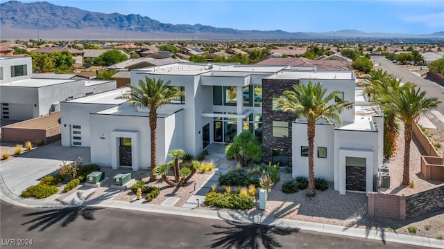 view of front facade featuring a residential view, a mountain view, and stucco siding