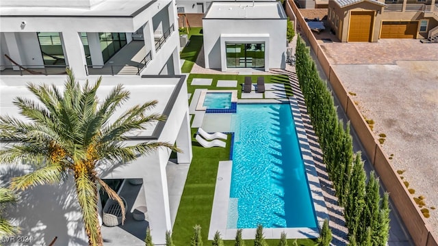 view of pool with a patio area and a pool with connected hot tub