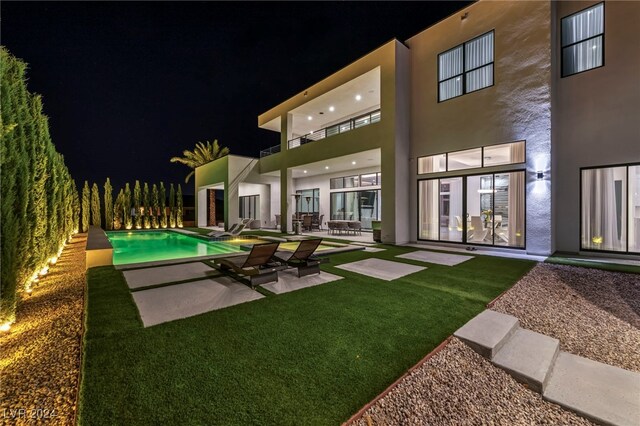 9760 Solar Ave, Las Vegas, NV 89149 - pool at twilight featuring a patio, an outdoor pool, and a yard
