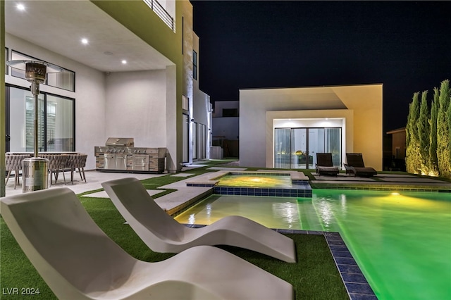 9760 Solar Ave, Las Vegas, NV 89149 - pool at night with a pool with connected hot tub and grilling area