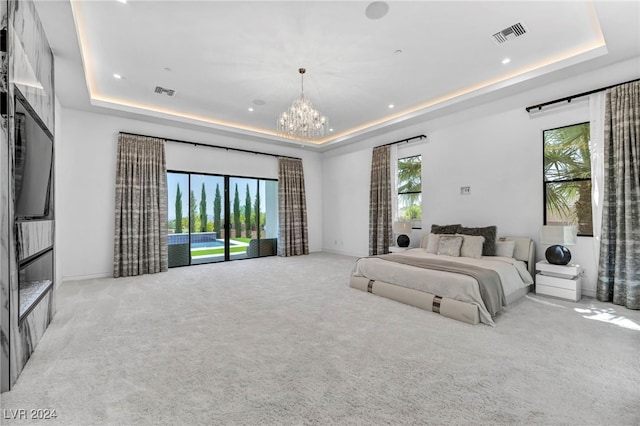 bedroom with a chandelier, a tray ceiling, and visible vents