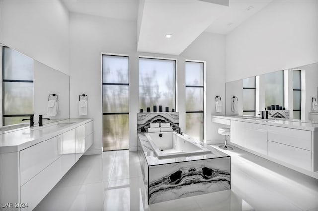 9760 Solar Ave, Las Vegas, NV 89149 - bathroom with two vanities, a tub with jets, and lofted ceiling