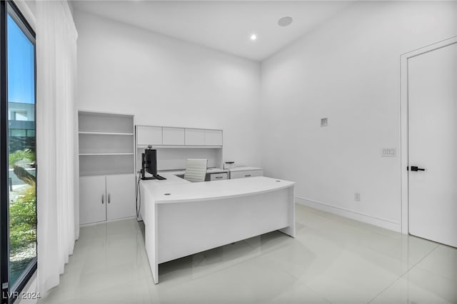 home office featuring baseboards, light tile patterned floors, and recessed lighting