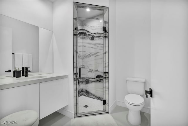 full bathroom featuring a marble finish shower, baseboards, vanity, and toilet