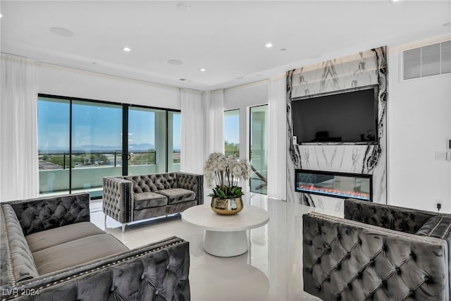 living room featuring recessed lighting, visible vents, and a fireplace