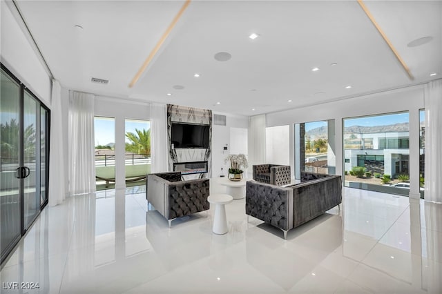 living area featuring recessed lighting, visible vents, and light tile patterned floors