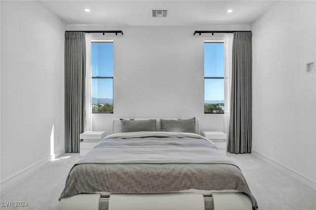 carpeted bedroom with visible vents and baseboards