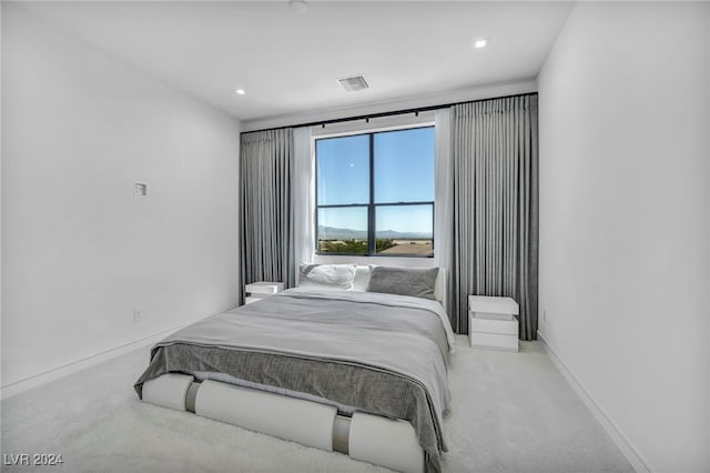 carpeted bedroom with baseboards and visible vents