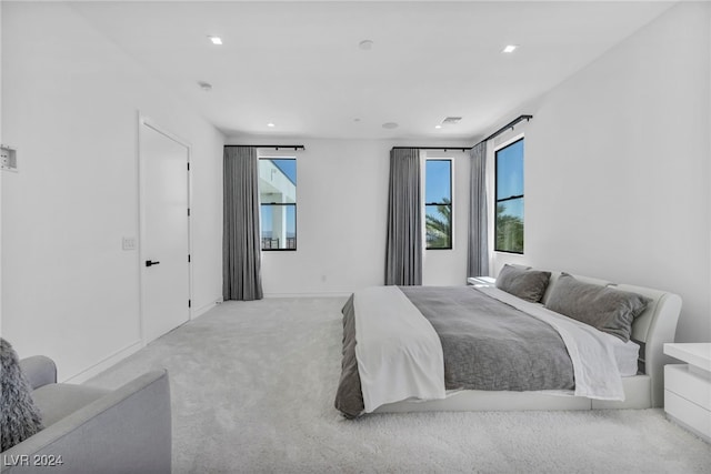 bedroom with carpet flooring, visible vents, and multiple windows