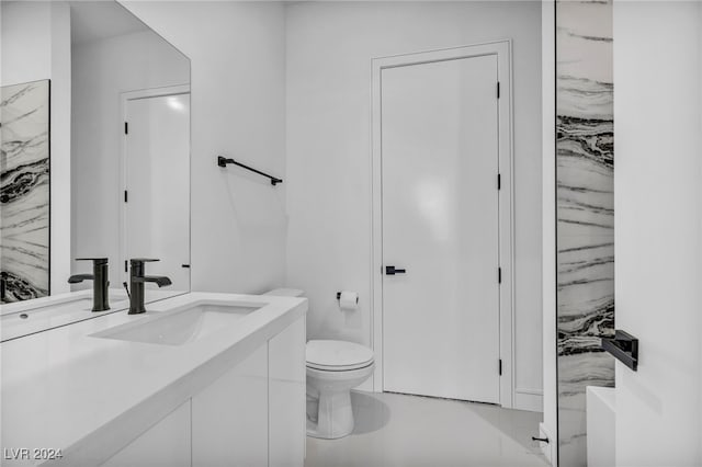 bathroom with toilet and vanity