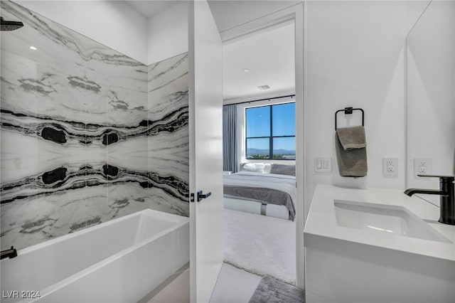 ensuite bathroom featuring tub / shower combination, connected bathroom, and vanity